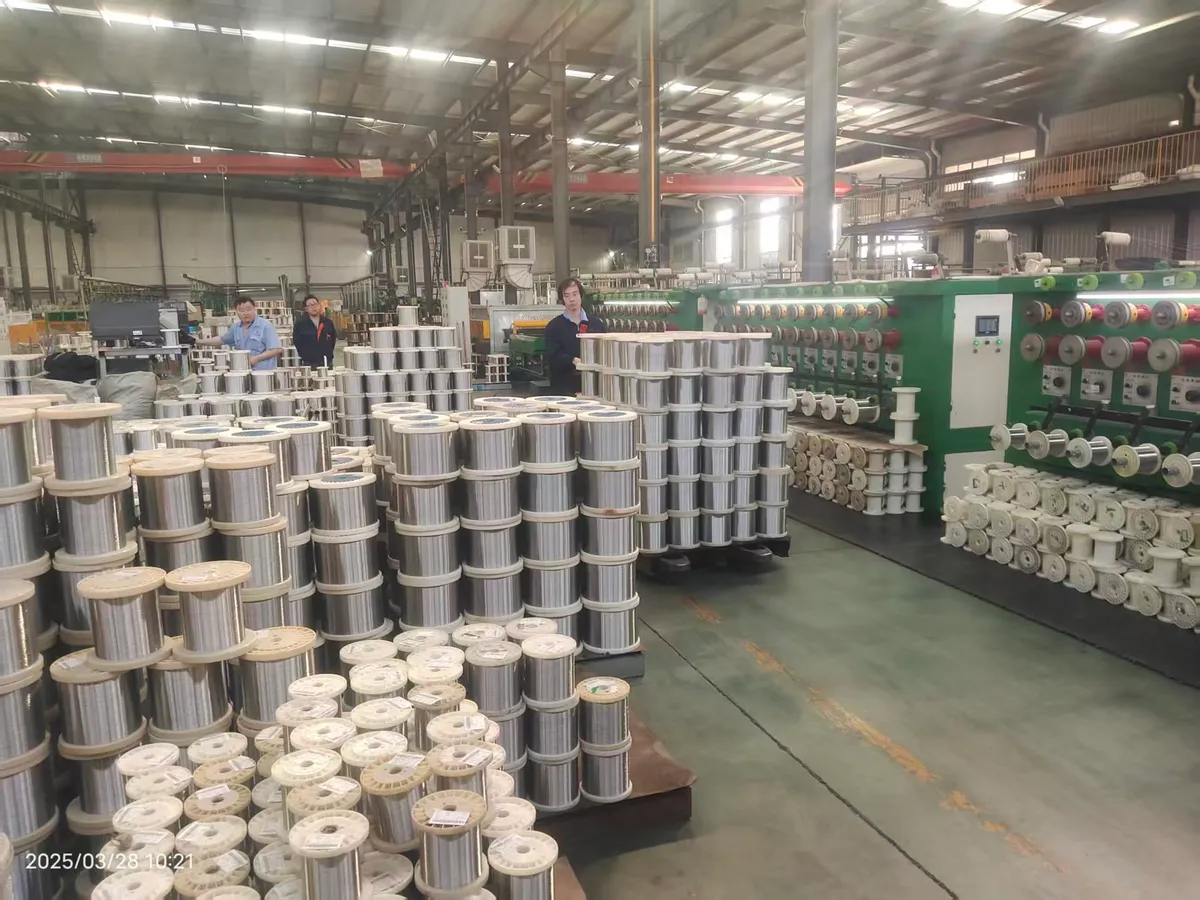 Wire drawing workshop with payoff coils and production equipment